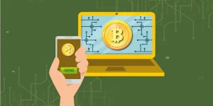 Sending Bitcoin from a mobile phone to a laptop, symbolizing how cryptocurrency transactions work