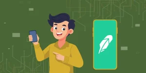 A happy person holding a smartphone and pointing towards a large mobile device displaying the Robinhood logo.
